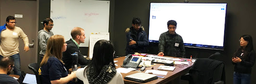 Multiple people discussing around a conference table