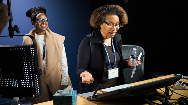 Two women engaging in a hands on experience within the Academic Innovation filming studios
