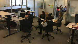 Two groups of faculty and staff sitting in circles