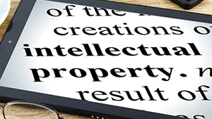 Photo of a tablet with the words "intellectual property" on the screen