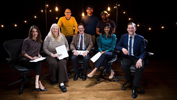 The Sleep Teach-Out instructional team, including learning experience designers, program managers and media production specialists in a filming studio surrounded by lightbulbs