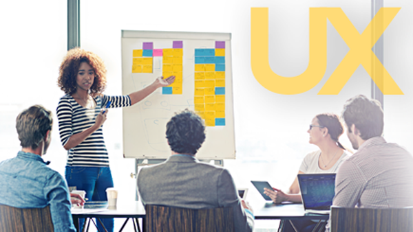 Woman presenting user experience designs to co-workers
