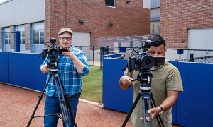 Jeff Butler and Cy Abdelnour filming on the softball field