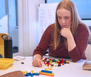 Sarah Dysart demonstrating stackability with legos