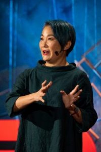 (Photo of Lisa Nakamura presenting.)