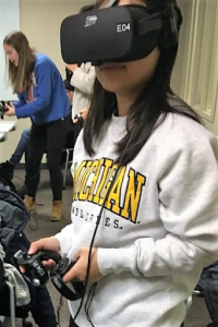 student using VR headset and controller