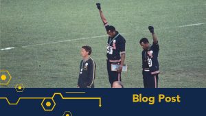 Peter Norman, John Carlos and Tommie Smith on the Olympic podium at the 1968 Olympic games. Carlos and Smith are raising black-gloved fists in the air