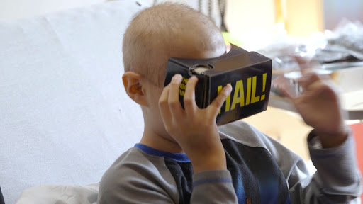 CS Mott Children's Hospital patient wearing vr headset with HAIL! written on the headset