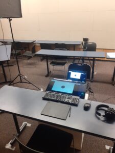 laptops and camera are set up in makeshift production studio