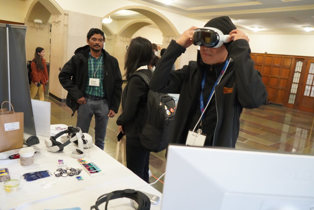 person puts on XR headset while others talk to each other in the background