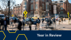Stylized photo of students walking the sidewalks and crosswalks near the Michigan Union