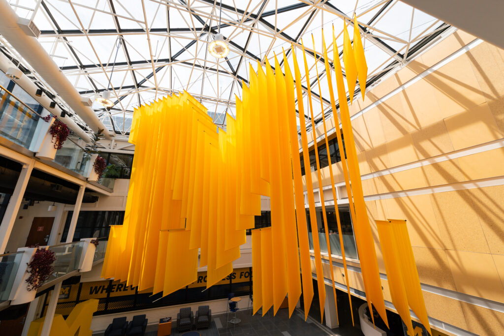 A hanging Block M art installation in the Student Activities Building.